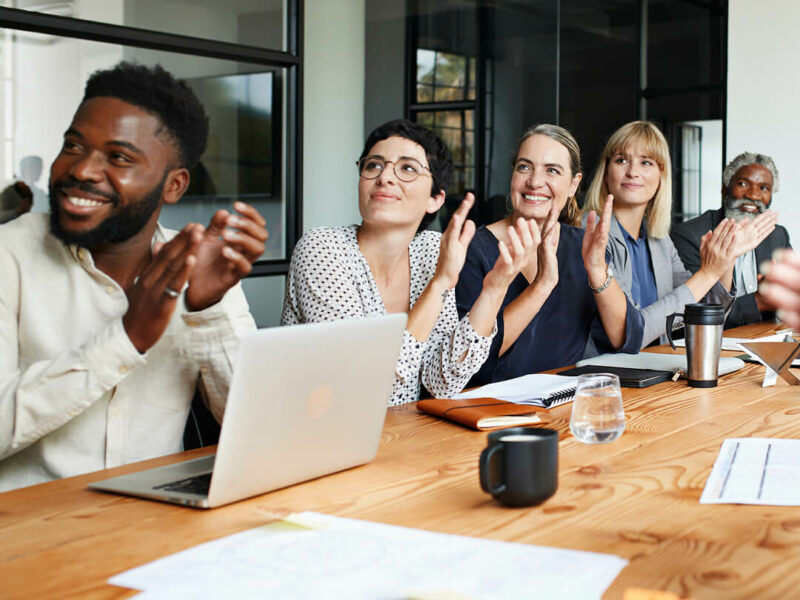 People in office clapping hands.